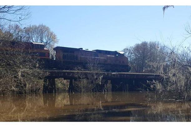 a train crossing a bridge over a river