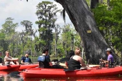 a group of people in a small boat in a body of water